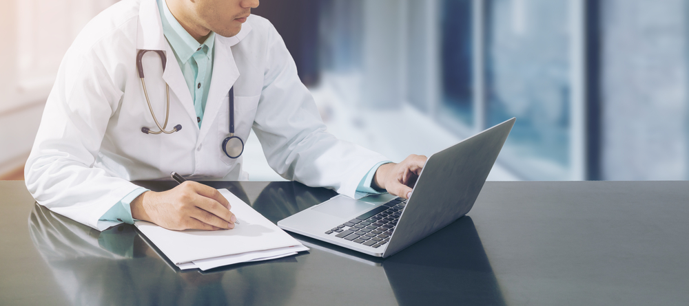 Doctor doing medical transcription on laptop